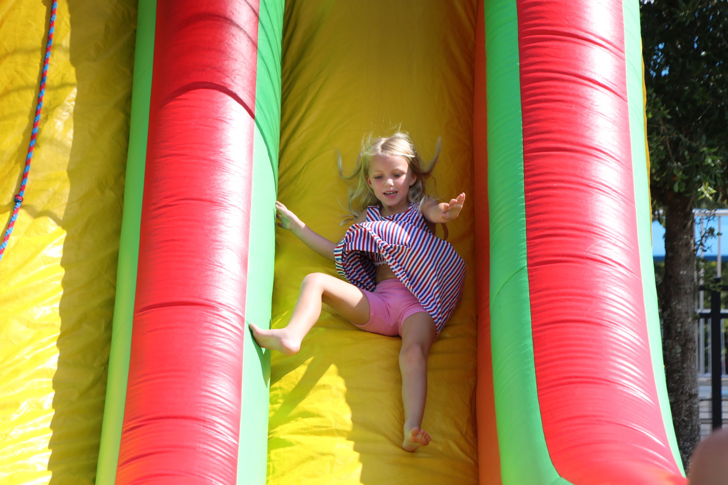 Haven Brantley zooms down one of the brightly colored bounce house slides. She will be a kindergartner at Valley Ridge and her sister, Aspen (not pictured), will be in third grade when school starts.